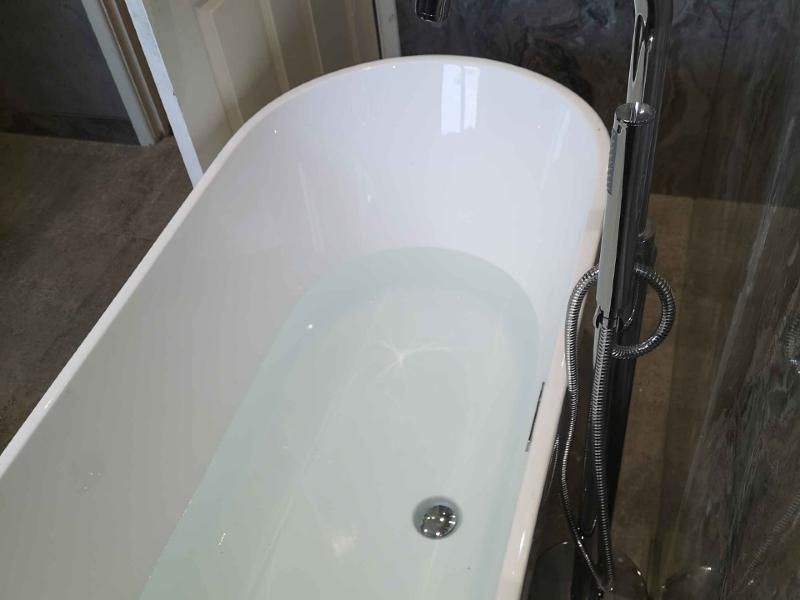 Freestanding bath with floor-standing chrome mixer, fitted by All Install
