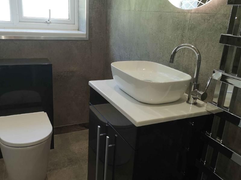 Bathroom with countertop basin and dark gloss vanity